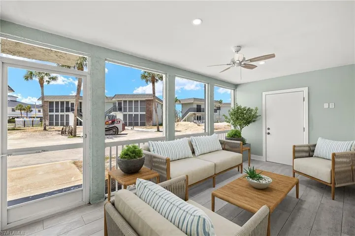 Virtual Imaging screened lanai featuring ceiling fan, ceramic plank tiles and an outdoor hangout area