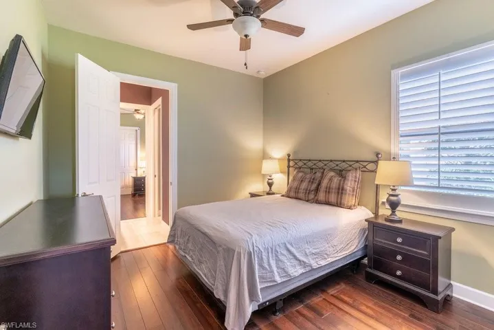 Bedroom featuring ceiling fan and dark hardwood / wood-style flooring