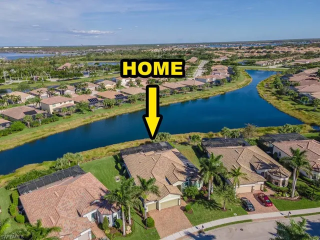 Birds eye view of property with a water view