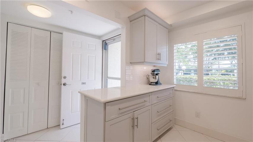This kitchen is open to the front foyer, includes LOADS of storage and extra countertop space. Quartz countertops, subway tile backsplash, roll outs in almost every cabinet, plantation shutters and MORE!