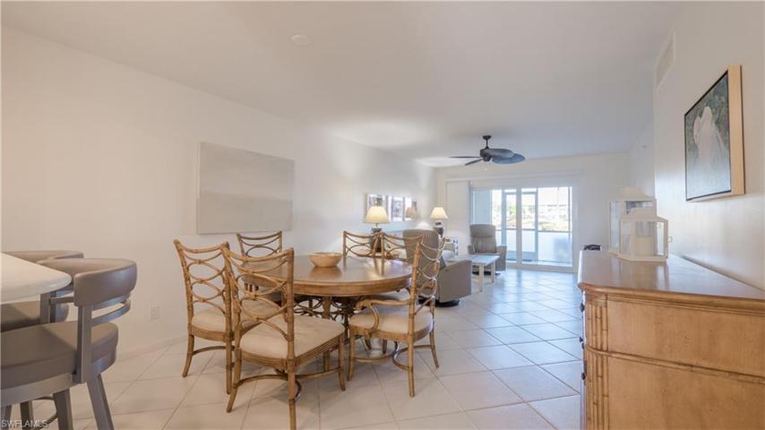 Diagonal tile flooring, Tommy Bahama furniture, custom bar stools, neutral white paint.