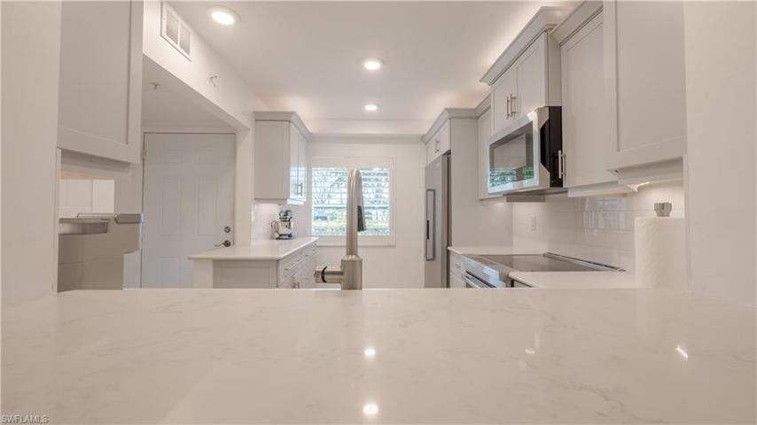 Another view of the kitchen. LED perimeter & sink task lighting, above and below cabinet lighting, Quartz countertops, subway tile backsplash JENN AIRE appliances.