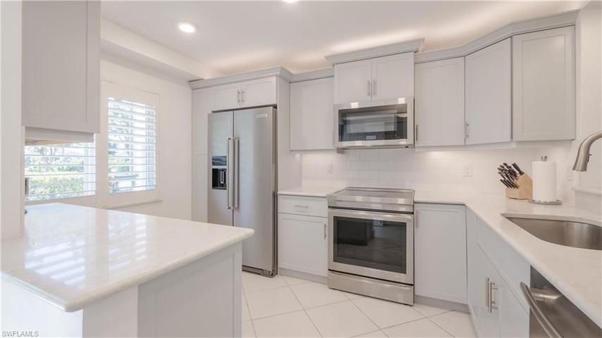 GORGEOUS CORNERSTONE remodeled kitchen. 4 way lighting, quartz countertops, deep vessel SS sink w/ gooseneck faucet, JENN AIRE appliances, counter depth refrigerator. PULL-outs GALORE, too!