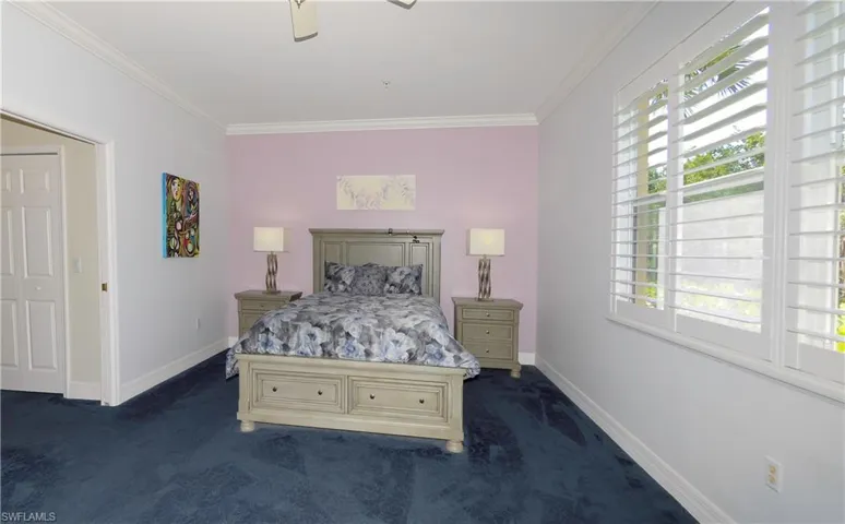 Primary Suite with plush carpet, Large windows, views of Preserve, Crown molding, Plantation Shutters, Luxurious en-suite Bath & 2 walk-in closets!