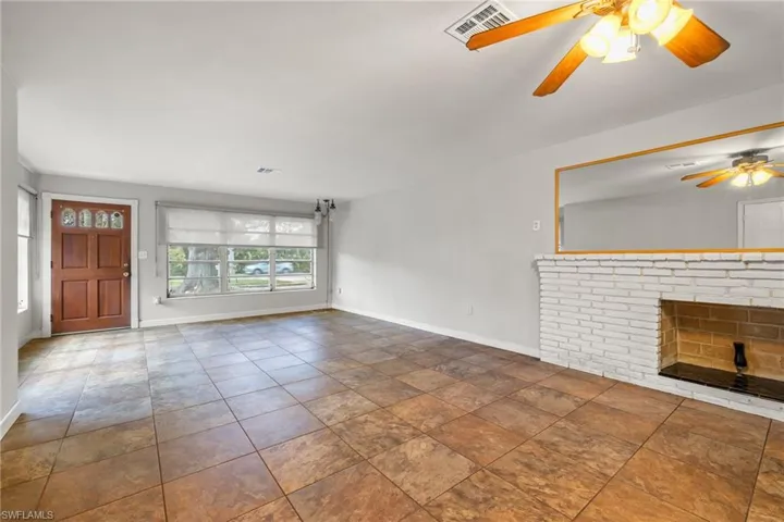 Open floor plan with spacious family room and a fireplace.