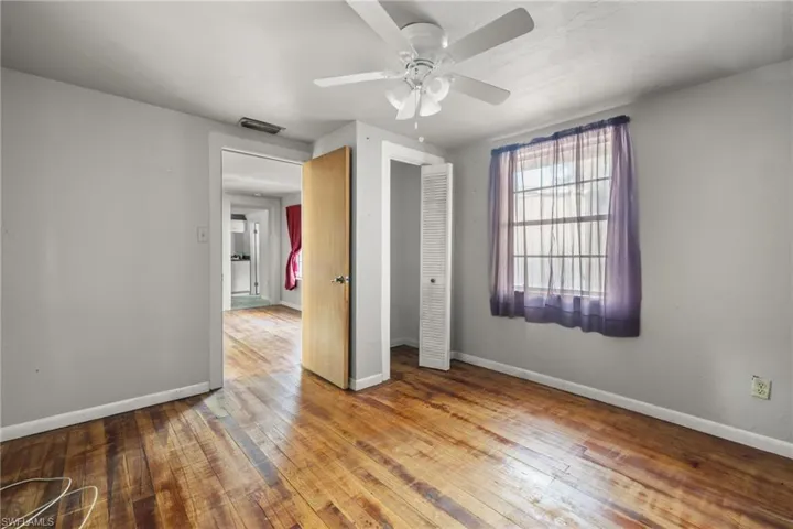 Bedroom in guest home with original wood floors.