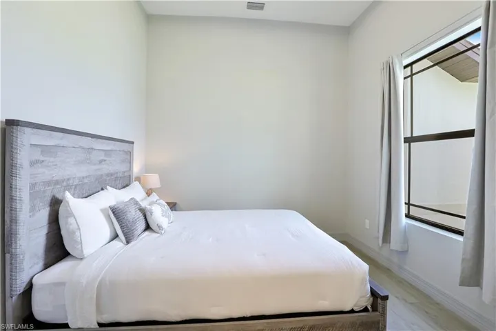 Bedroom featuring light wood finished floors and baseboards