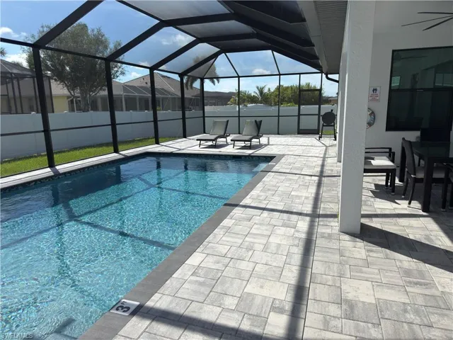 View of pool featuring a sunroom, a patio, and a lanai