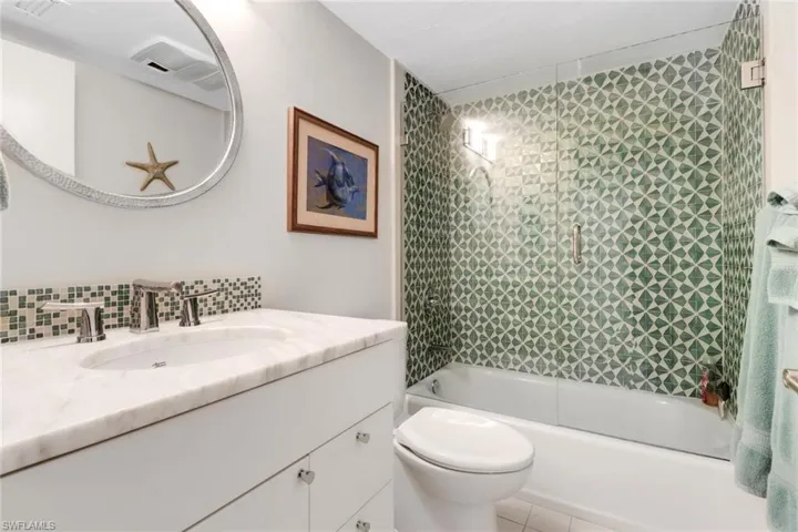 Full bathroom with vanity, bathing tub / shower combination, and tile patterned floors