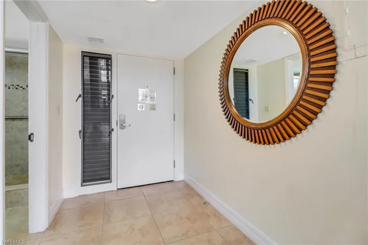 Entryway featuring baseboards and light tile patterned floors