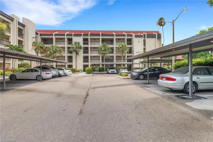 View of property featuring covered parking