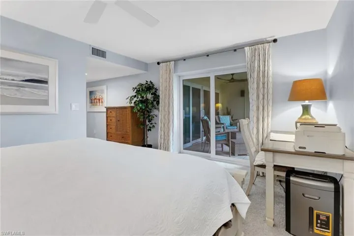 Bedroom featuring access to exterior, light colored carpet, and ceiling fan