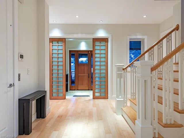 Entry foyer, elevator to left, and stairs to private owners quarter or first level area with garage, workshop, social room, and exercise room