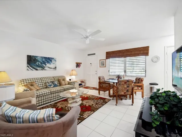 Tiled living room featuring ceiling fan