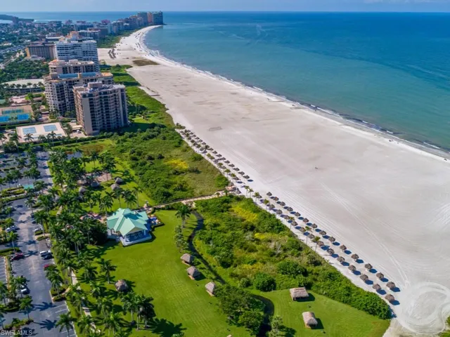 Drone / aerial view with a water view and a beach view