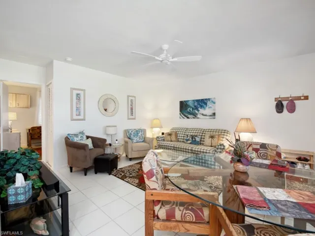 Living room with ceiling fan and light tile patterned floors