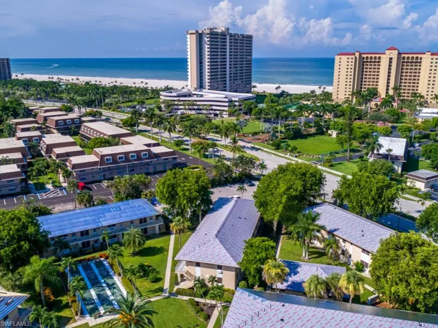 Drone / aerial view with a water view and a view of the beach