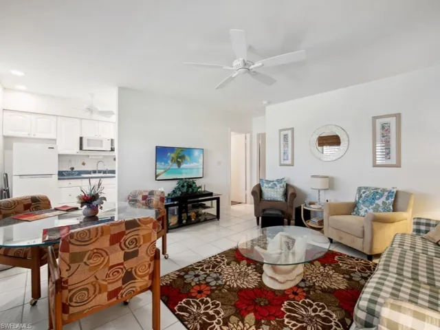 Living room featuring ceiling fan, sink, and light tile patterned floors