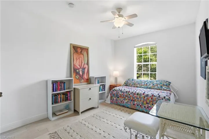 Bedroom with light wood-type flooring and a ceiling fan