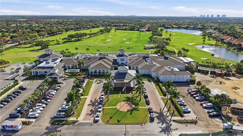 Aerial overview of property's location with a large body of water, a golf club, and nearby suburban area