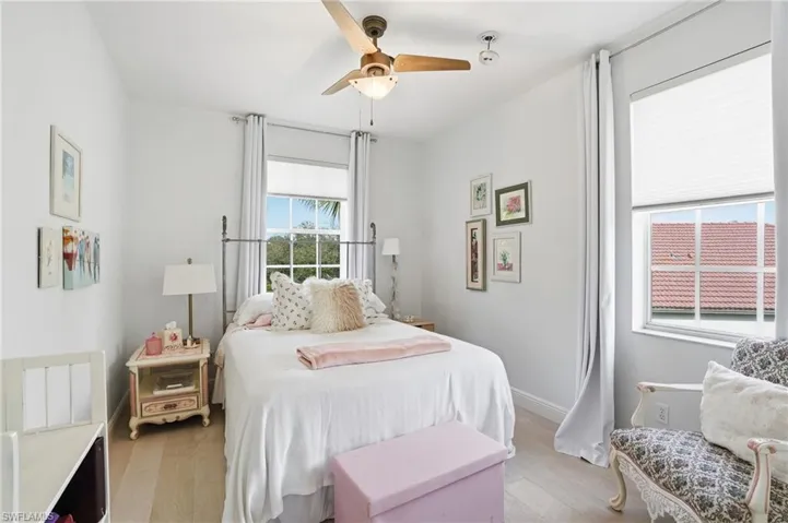 Bedroom with light wood finished floors and ceiling fan