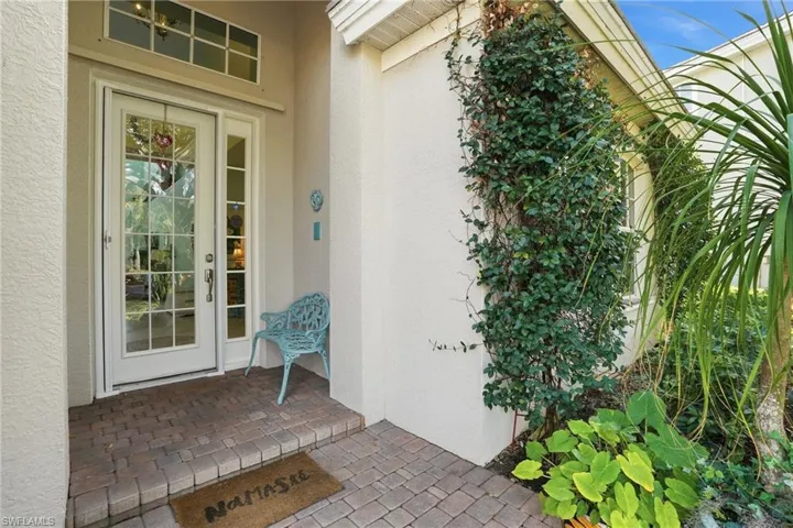 Doorway to property featuring stucco siding