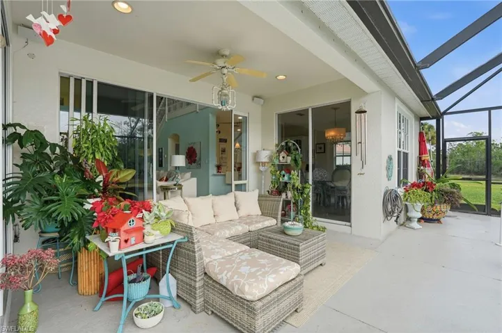 Sunroom / solarium featuring a ceiling fan, a patio area, and plenty of natural light