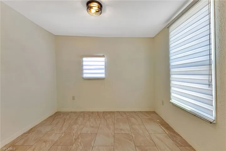 Spare room featuring light tile flooring