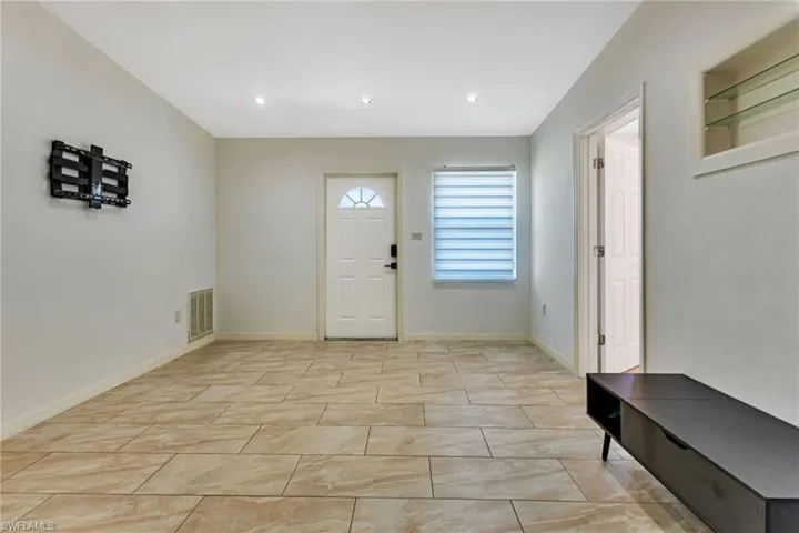 Foyer entrance with light tile floors