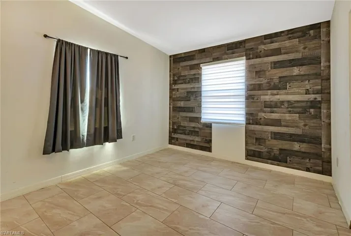 Empty room with light tile flooring
