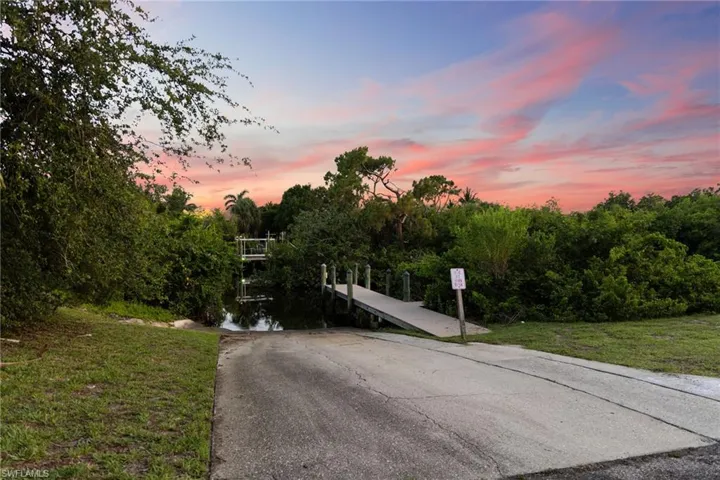 View of asphalt driveway with a boat ramp