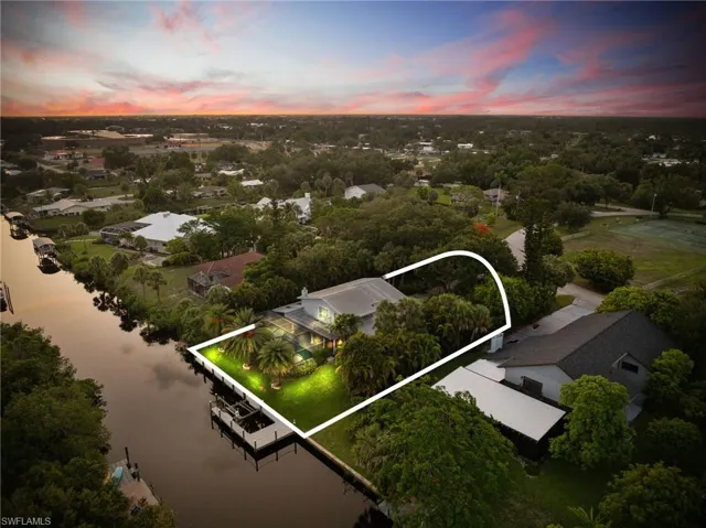Aerial view of property's location featuring a nearby body of water and property parcel outlined