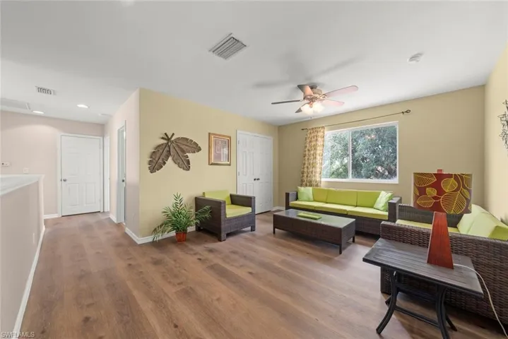 Upstairs flex space for a den, office, play area, family room, or whatever you want featuring laminate floors, a ceiling fan, a window for natural light