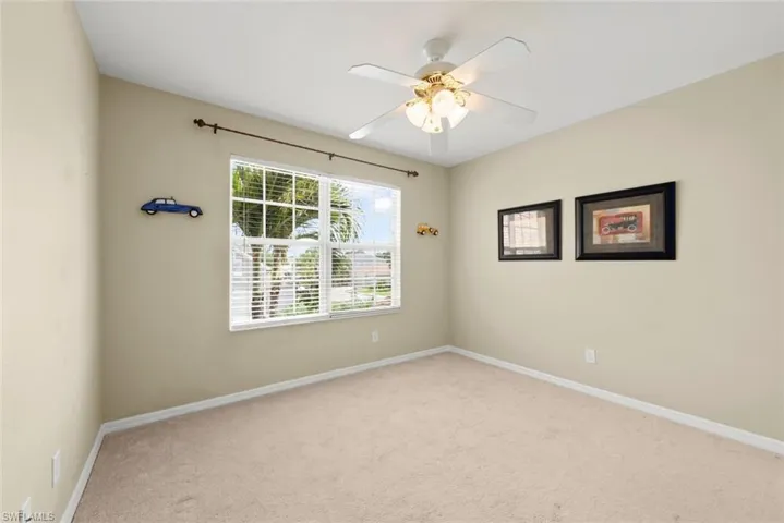 Carpeted bedroom #3 featuring a window and ceiling fan