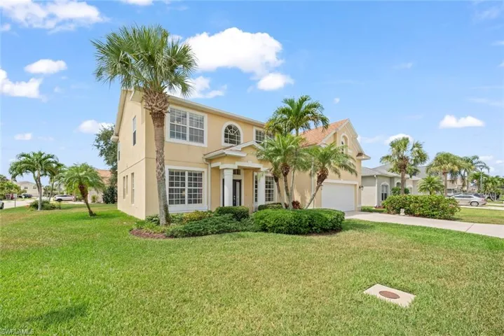 View of front of property with concrete driveway, a front lawn, a garage, and stucco siding