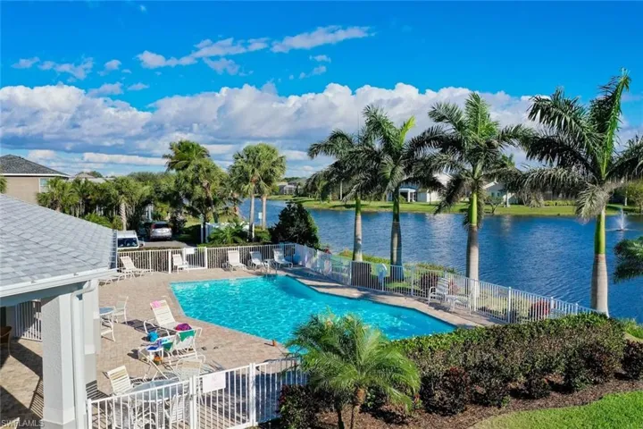 Community pool featuring a water view