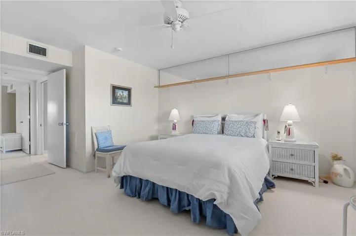 Carpeted bedroom with a ceiling fan