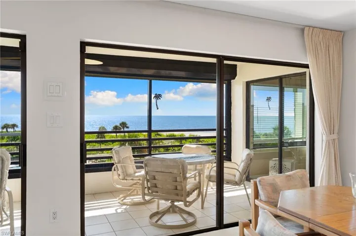 Tiled dining space featuring a water view