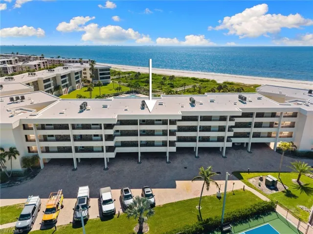 Drone / aerial view of apartment complex / building and a nearby body of water