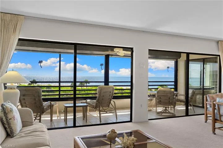 Carpeted living room featuring a water view