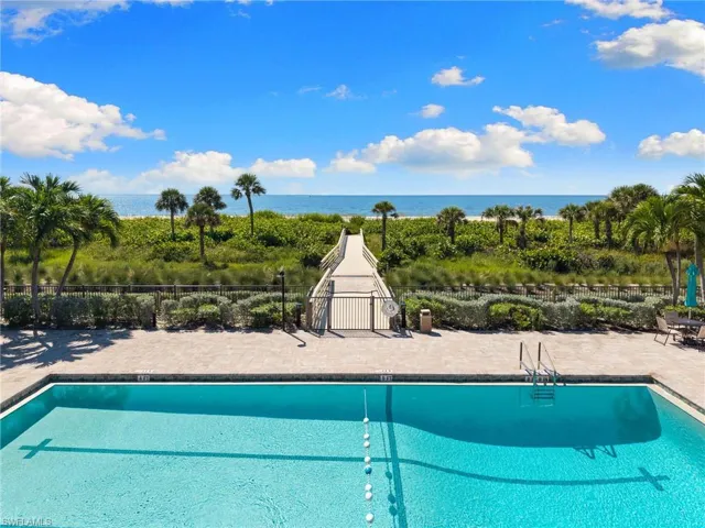 Community pool with a patio and a water view