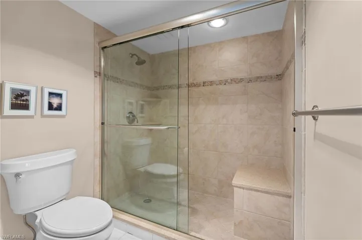 Bathroom with toilet and a stall shower