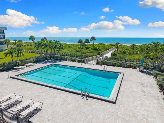 Community pool featuring a patio and a water view
