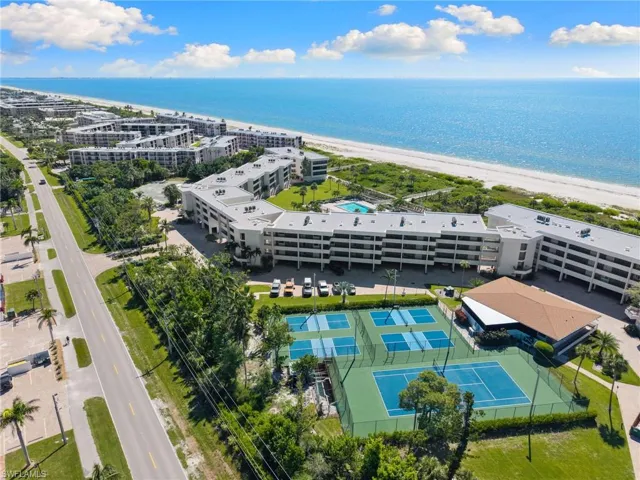 Aerial view of extended coastline and apartment complex / building