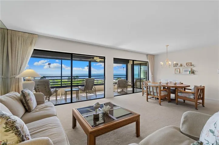 Carpeted living area with a chandelier