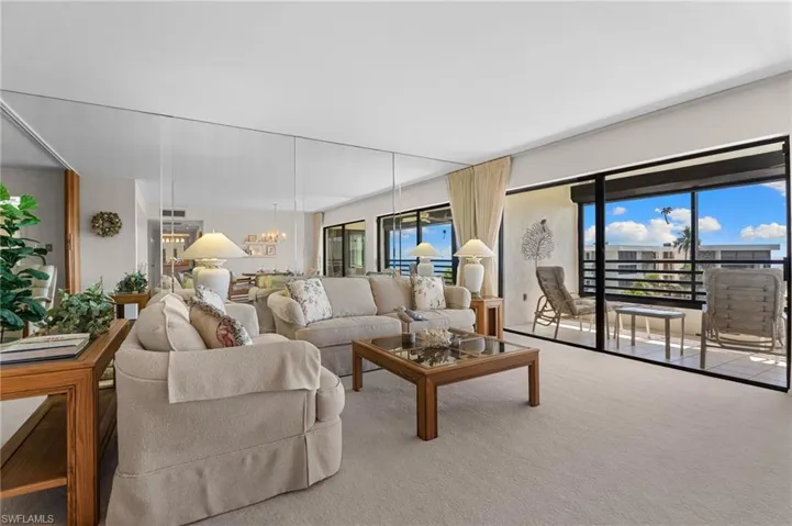 Living area with a chandelier and carpet floors
