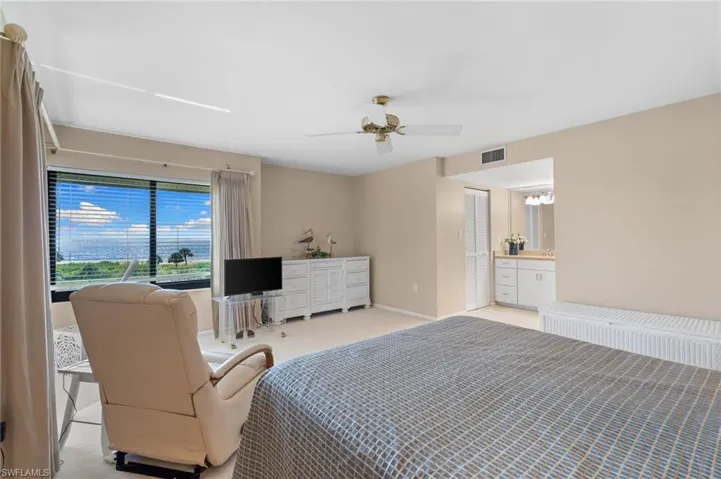 Carpeted bedroom featuring baseboards and a ceiling fan