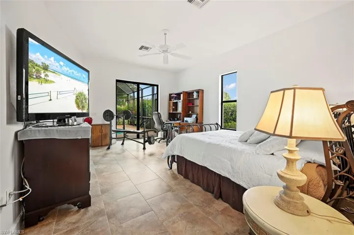 Bedroom with ceiling fan and access to exterior
