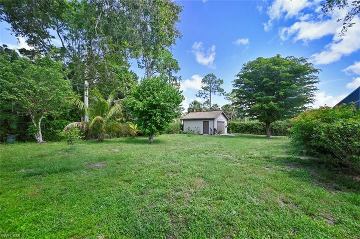 View of green lawn with an outbuilding