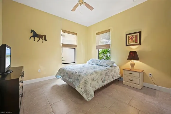 Bedroom with baseboards and ceiling fan